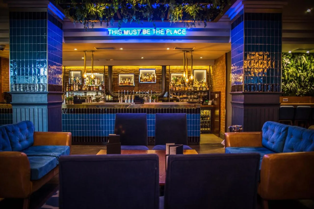 A restaurant with couches and a bar at night at Malmaison Newcastle in Newcastle upon Tyne