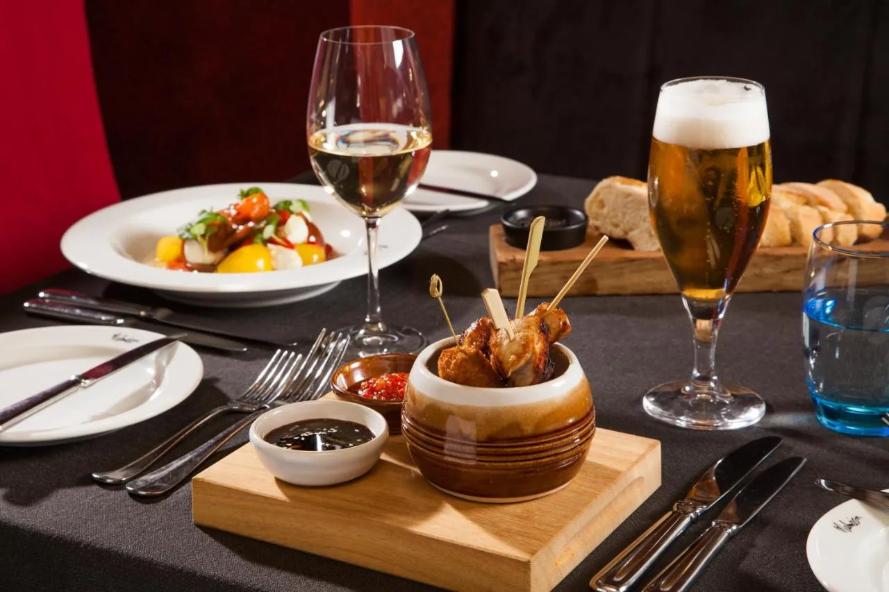 A table with glasses of beer and a bowl of food at Malmaison Newcastle in Newcastle upon Tyne